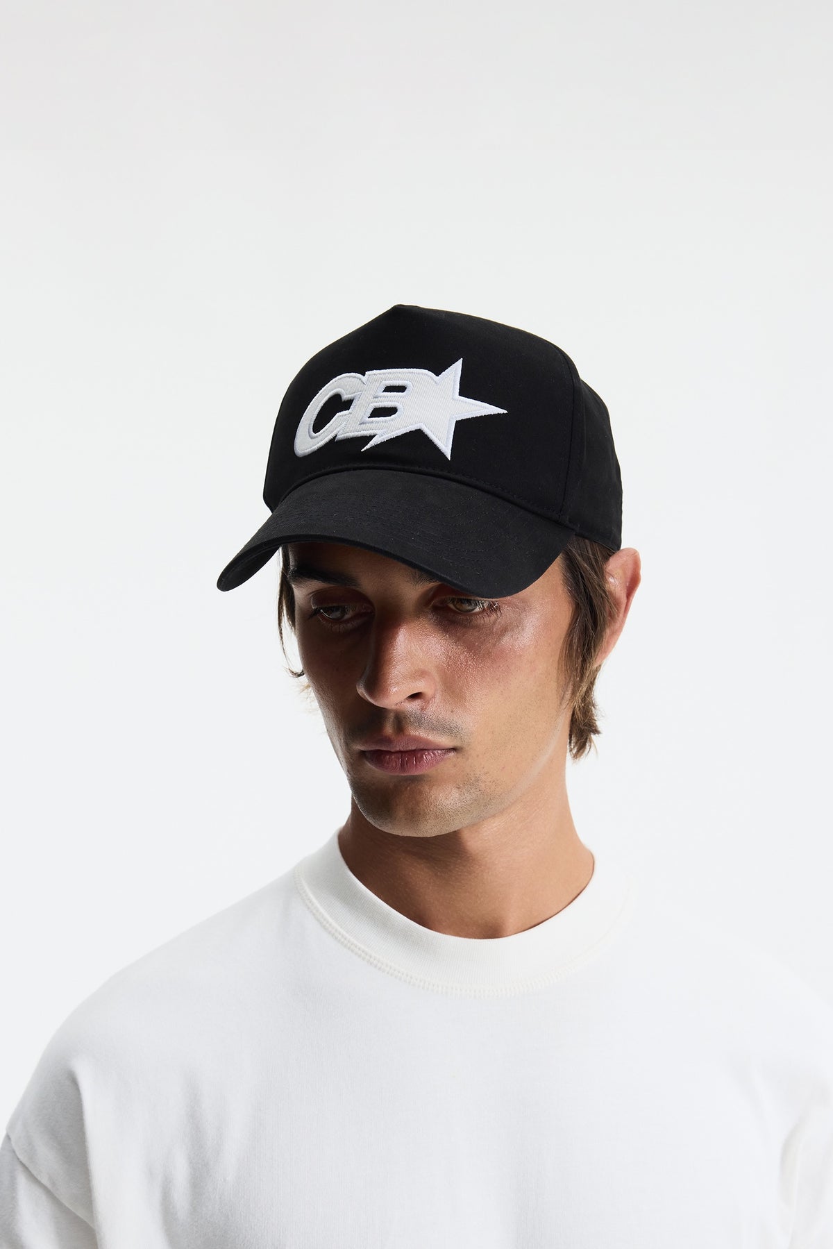 Black cap with a white logo on a light gray background
