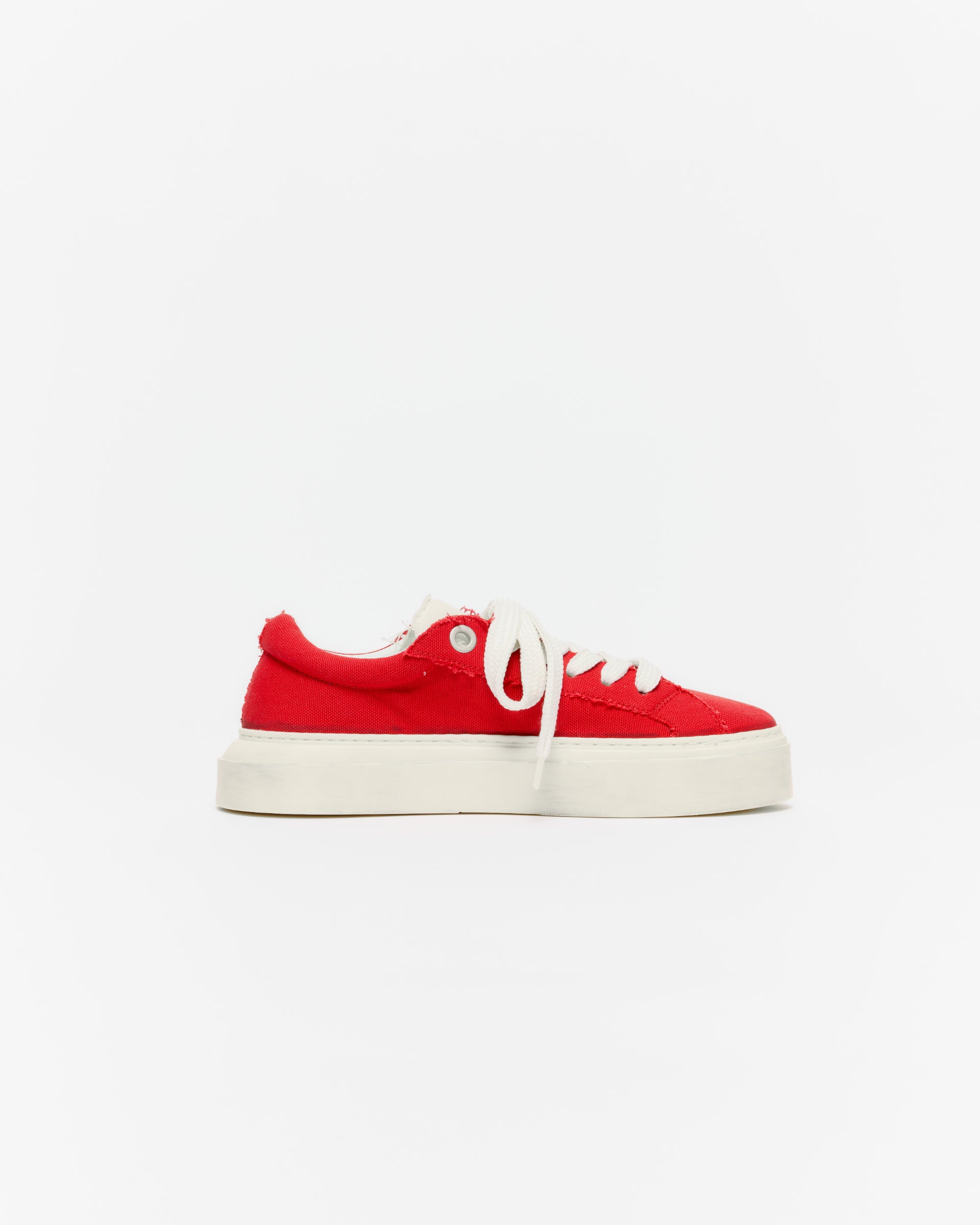Cole Buxton Red sneaker with white laces on a light gray background