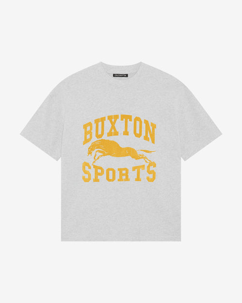 A light gray heather crewneck t-shirt featuring a yellow distressed graphic print that reads 'BUXTON SPORTS' with a running horse in the center.