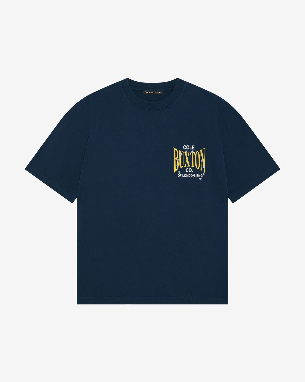A navy blue short-sleeve crewneck t-shirt with a yellow and white graphic print on the left chest reading 'COLE OF BUXTON CO. LONDON, ENGLAND'.