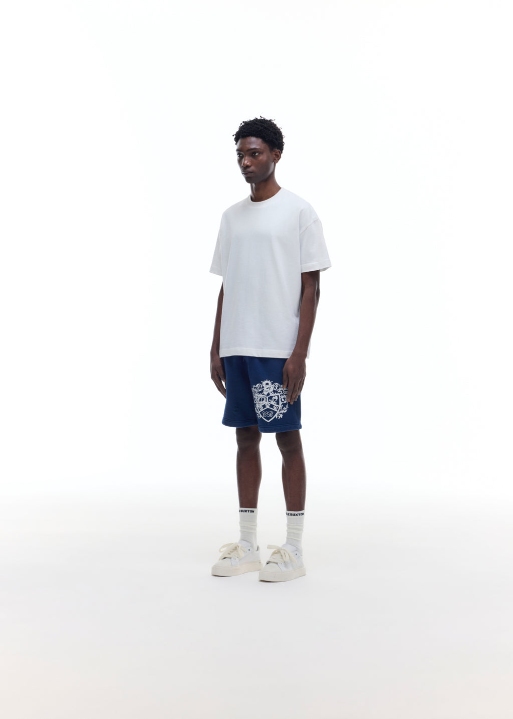 DISTRESSED COLLEGIATE CREST SHORTS